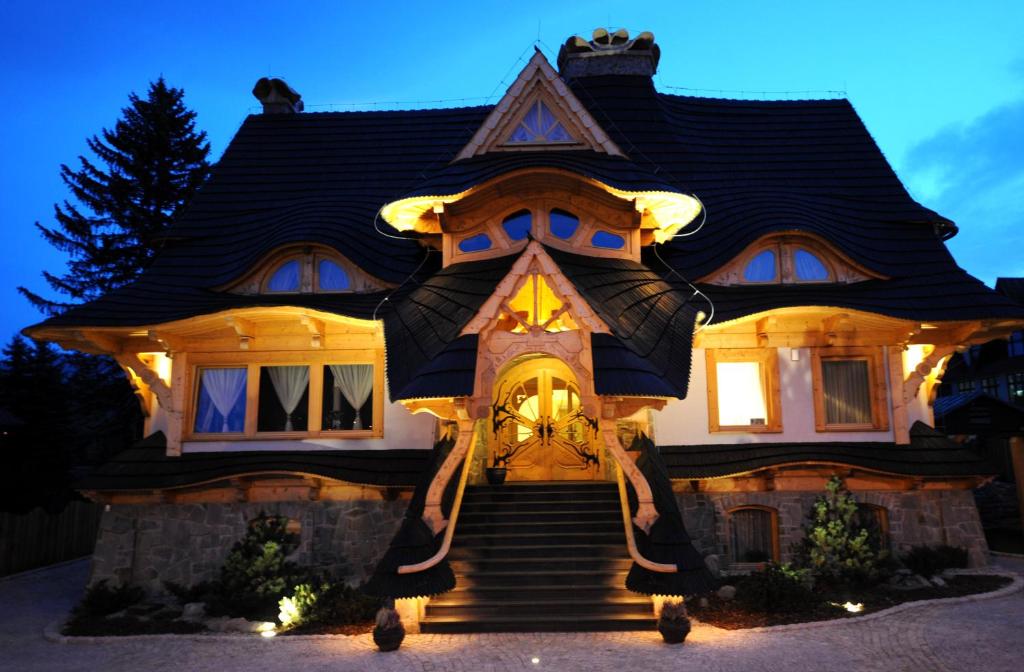 a home with a large house with lights on it at Willa Kominiarski Wierch in Zakopane