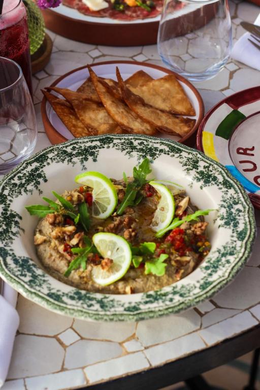 a plate of food on a table with french fries at Le Palazzo in Essaouira