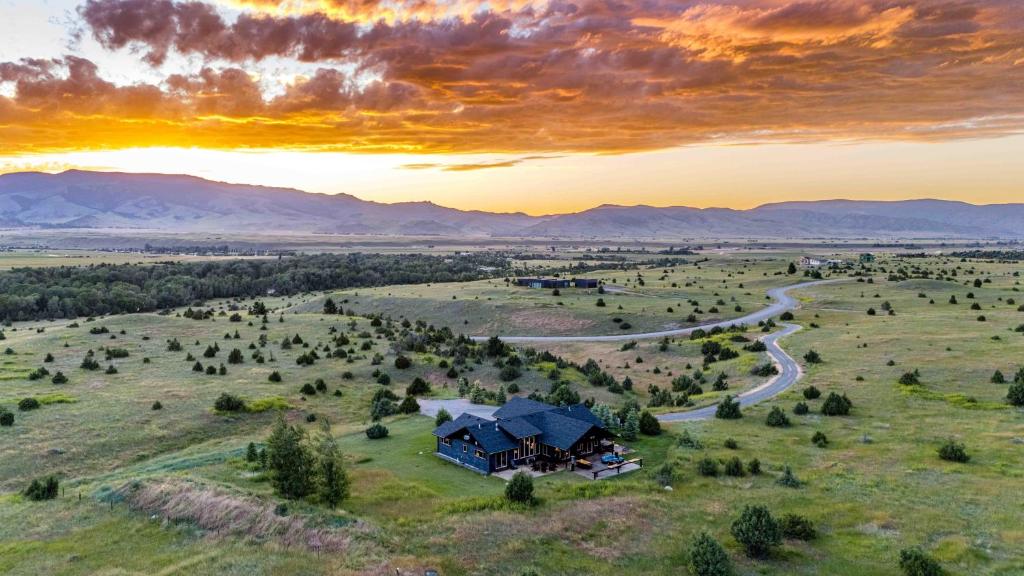 an aerial view of a house in a field with a road at Mountain Sanctuary in Livingston