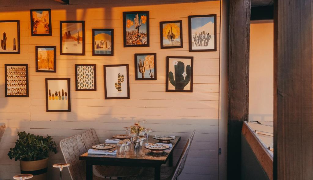 a table in a restaurant with pictures on the wall at Le Palazzo in Essaouira