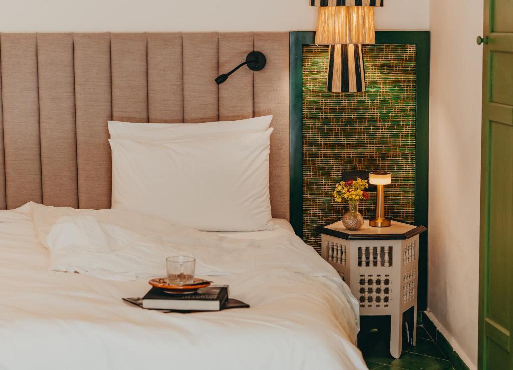 a bed with a plate of food on top of it at Le Palazzo in Essaouira