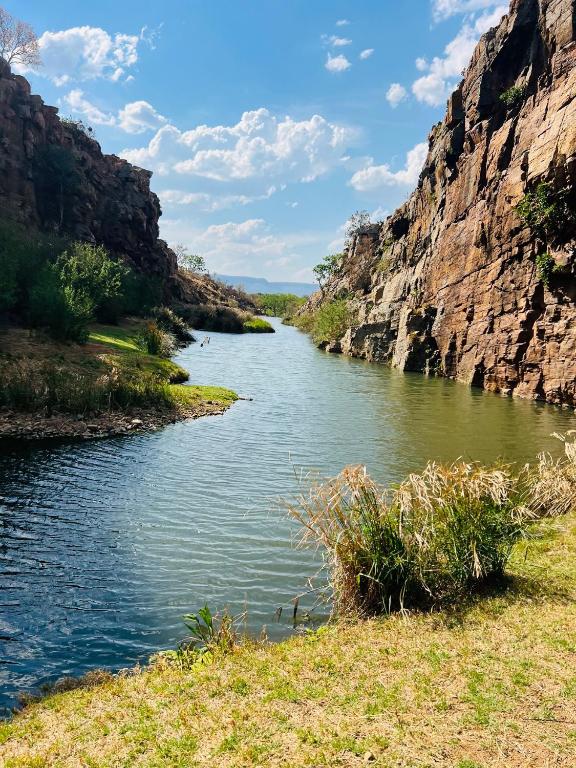 a river in the middle of a canyon at Bartons folly rose guesthouse in Hekpoort