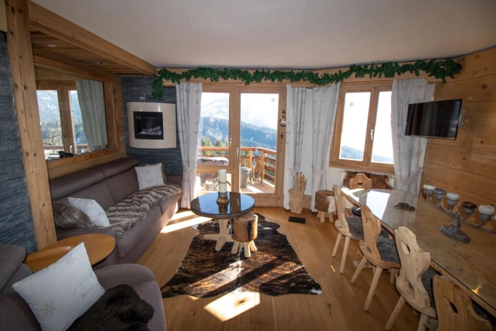 a living room with a couch and a table at Le Bristol - Villars Bristol Apartments in Villars-sur-Ollon
