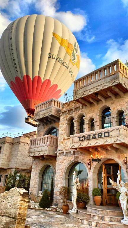 a hot air balloon in front of a building at Cappadocia Chiaro in Uçhisar