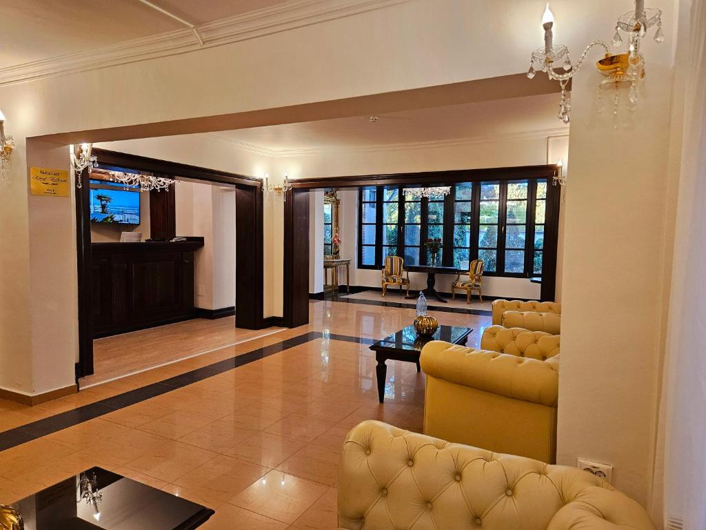 a living room with a couch and a table at Hotel Royal Plaza in Timişoara