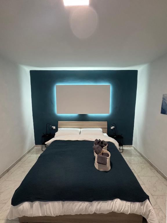 a bedroom with a large bed with a blue headboard at Maison Al Vecchio Cinema in Alife