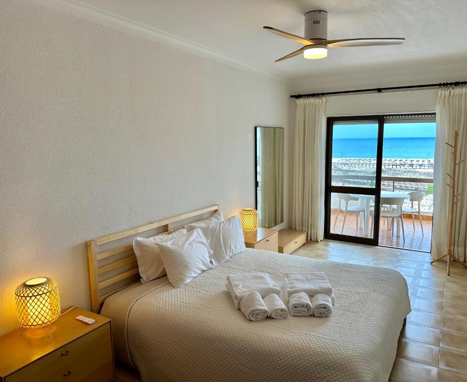 a bedroom with a bed with two towels on it at T1 Vista Baía Monte Gordo in Monte Gordo
