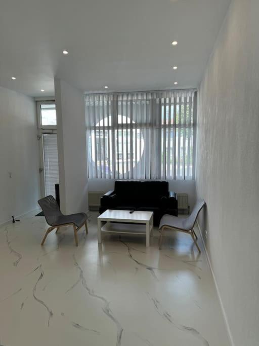 a living room with a couch and two chairs at Gemütliche Wohnung in Heilbronn in Heilbronn
