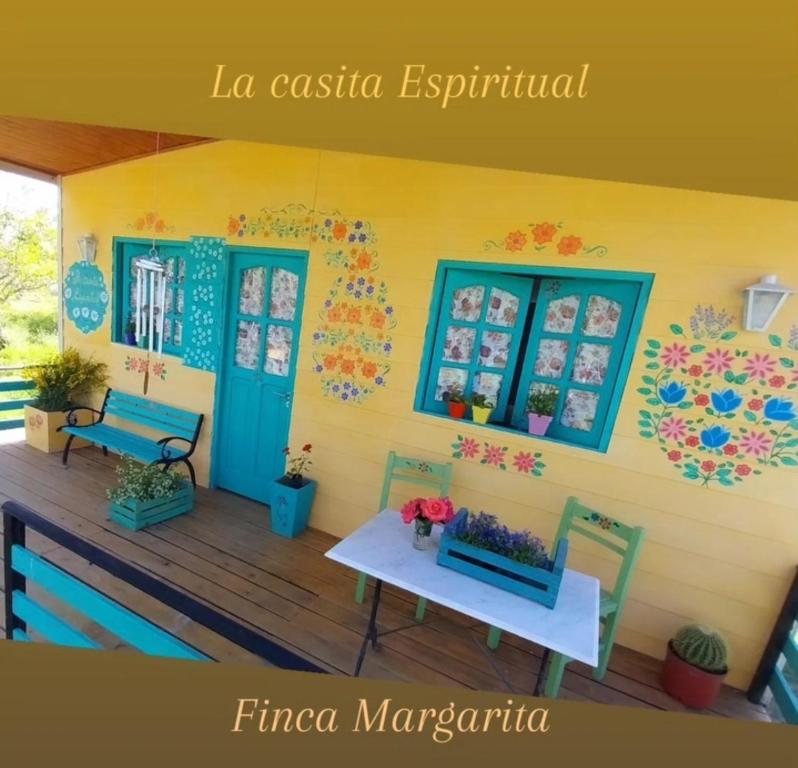 a house with a table and chairs on a deck at La casita Espiritual in San Rafael