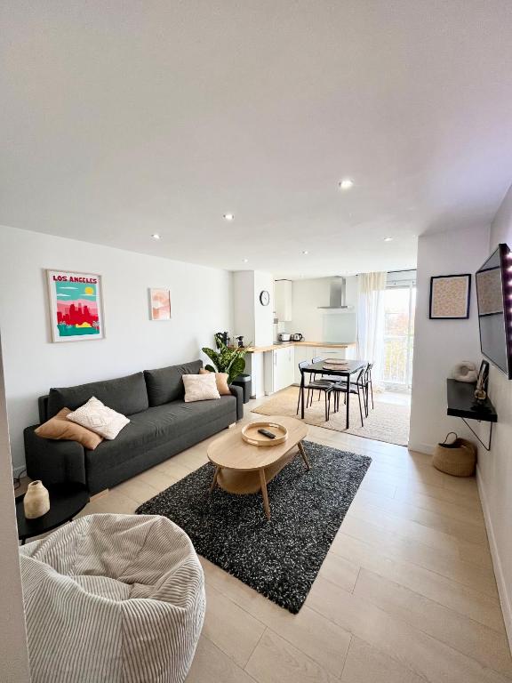 a living room with a couch and a table at Appartement les Falaises in Cap d'Agde