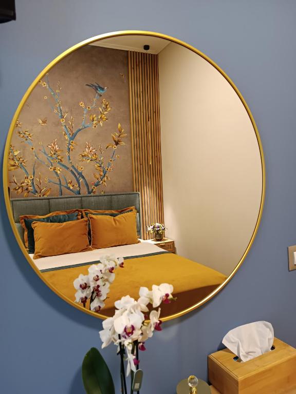 a bedroom with a large mirror on the wall at Filoxenia Luxury Apartment in Nafplio