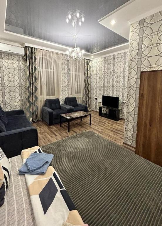 a living room with a large bed and a couch at Квартира у Айрин in Vanadzor