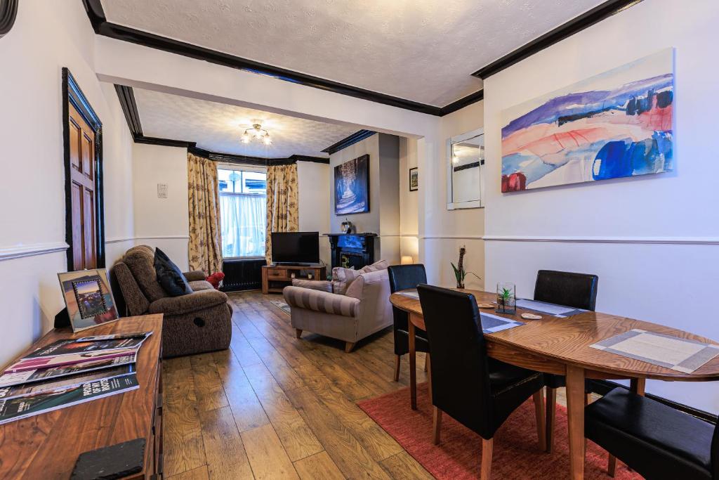 a living room with a table and a couch at Londonderry House in Stockton-on-Tees