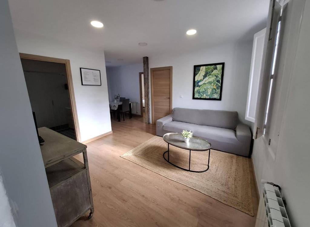a living room with a couch and a table at La Casona Santander Centro in Santander