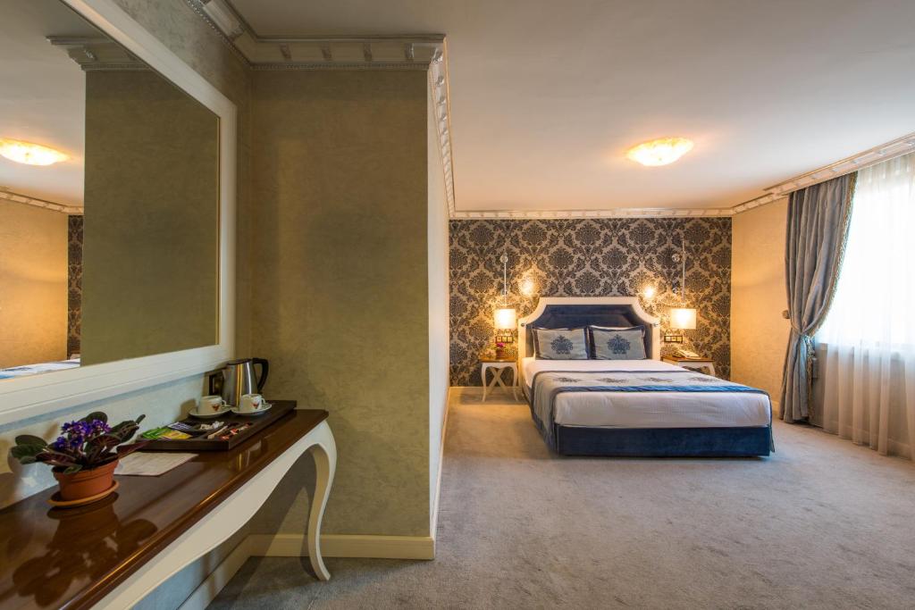 a hotel room with a bed and a mirror at Antea Hotel Oldcity -Special Category in Istanbul