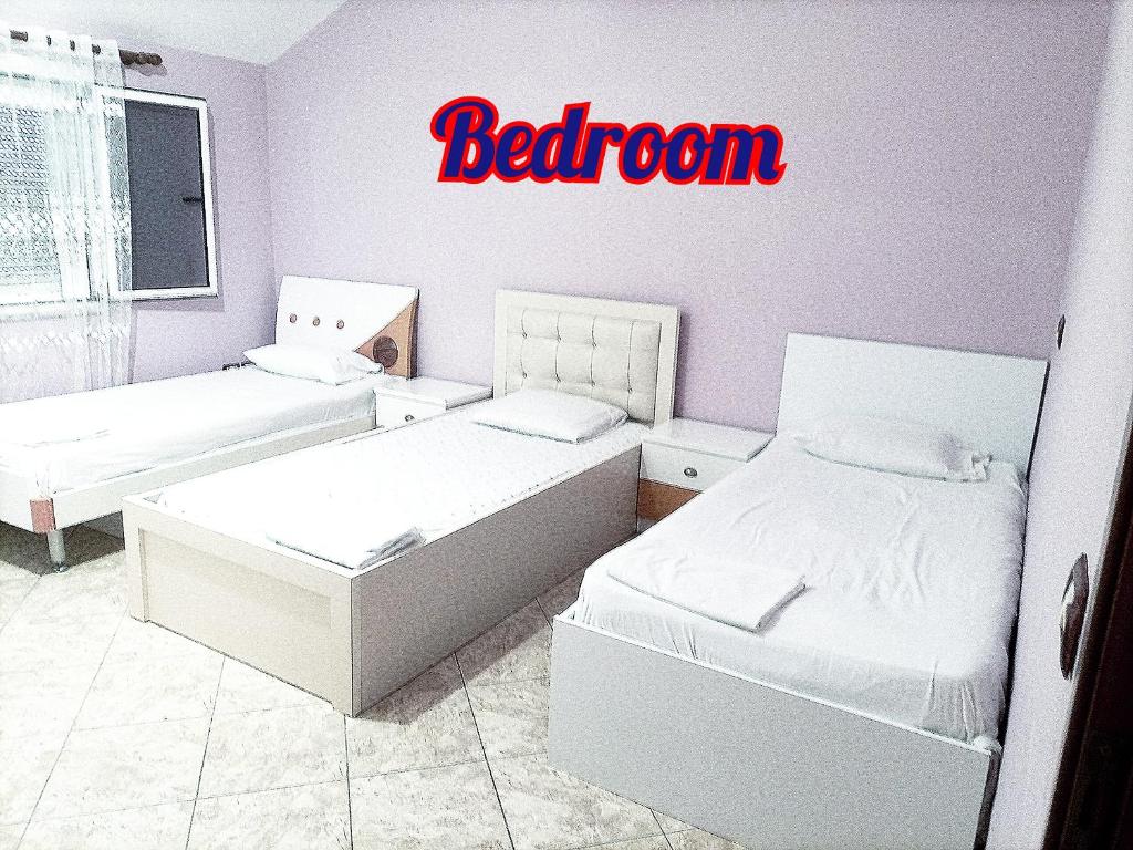 a bedroom with two beds and a sign that reads bedroom at Villas Mari-Anna for rent best view in Durrës