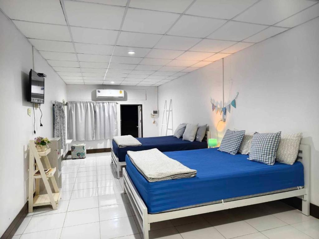 Postel nebo postele na pokoji v ubytování บ้านวิตามินซี จันทบุรี