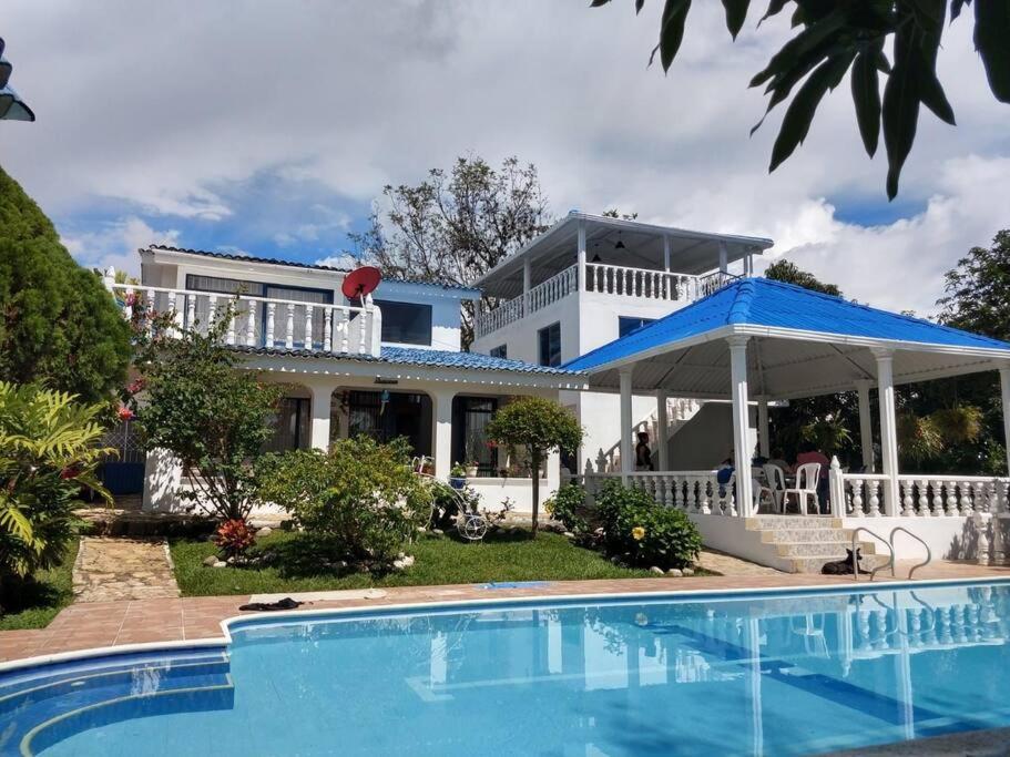 a house with a swimming pool in front of it at Villa ilusiones in Grecolandia