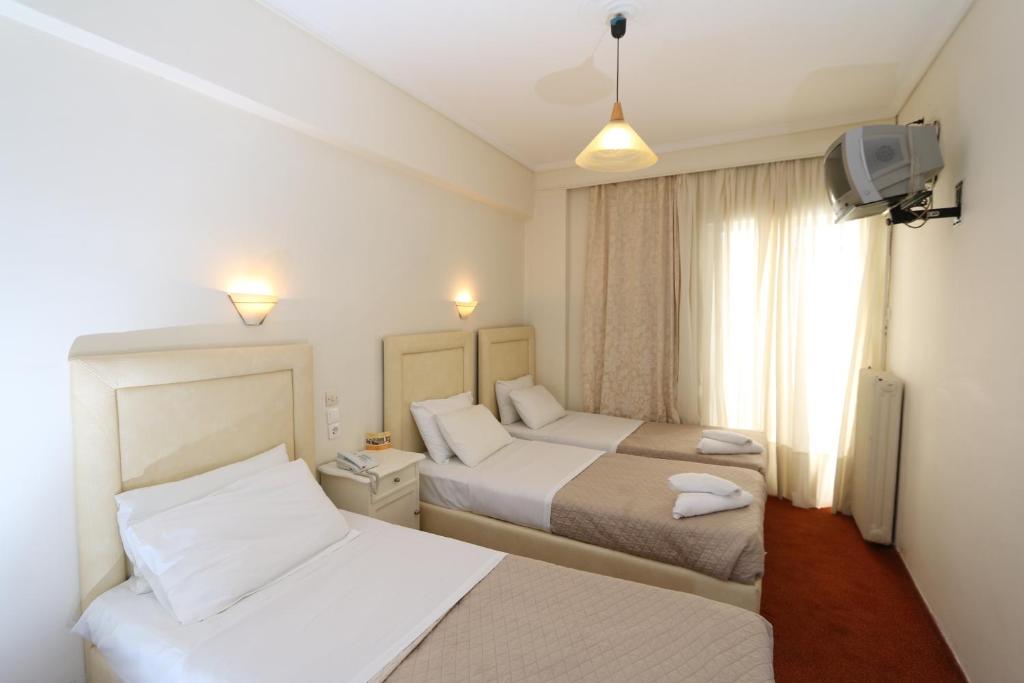 Postel nebo postele na pokoji v ubytování Athens Delta Hotel