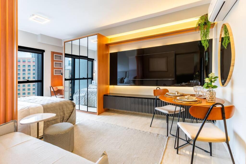 a hotel room with a bed and a table and a bedroom at Brasília a 400m do metrô in Brasilia