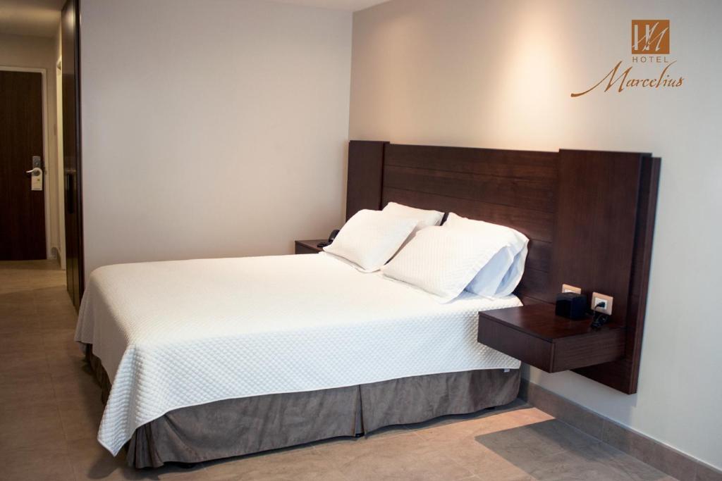 Postel nebo postele na pokoji v ubytování Hotel Marcelius
