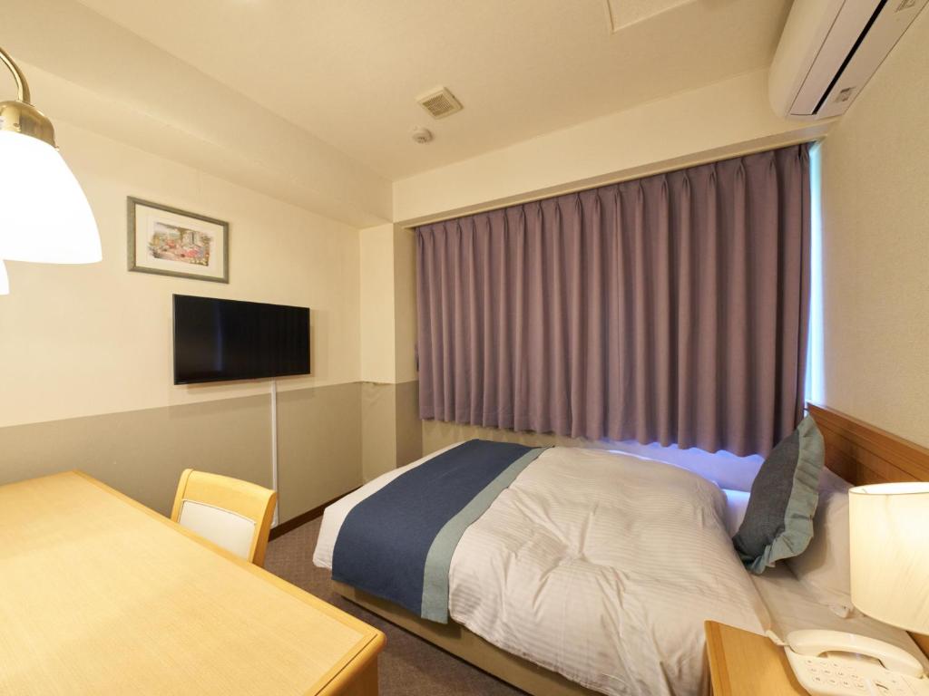 Postel nebo postele na pokoji v ubytování Hotel Areaone Wadayama