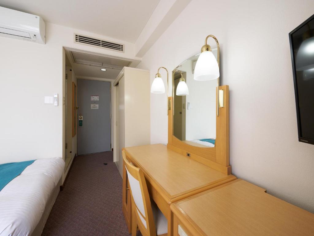 Postel nebo postele na pokoji v ubytování Hotel Areaone Wadayama