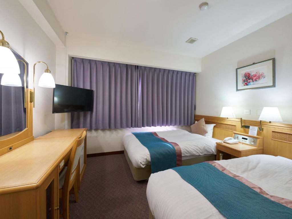 Postel nebo postele na pokoji v ubytování Hotel Areaone Wadayama