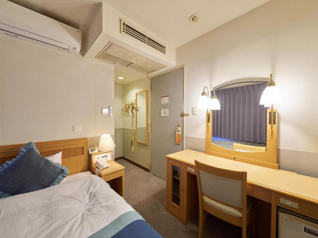 Postel nebo postele na pokoji v ubytování Hotel Areaone Wadayama