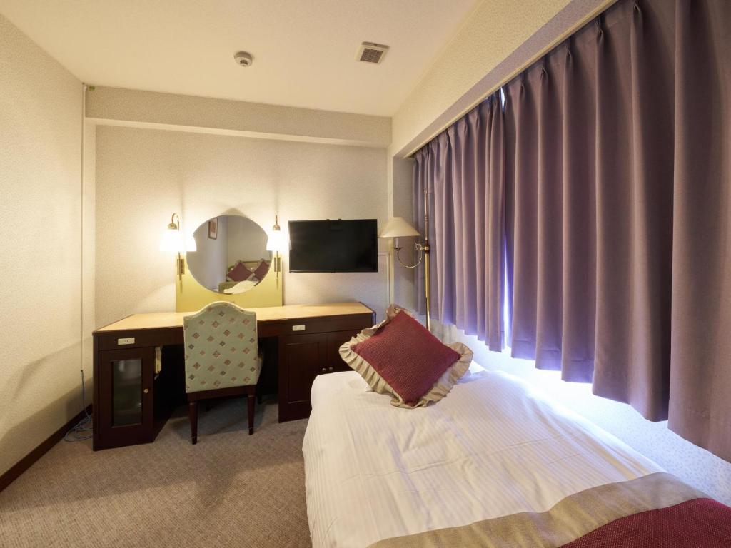 Postel nebo postele na pokoji v ubytování Hotel Areaone Wadayama