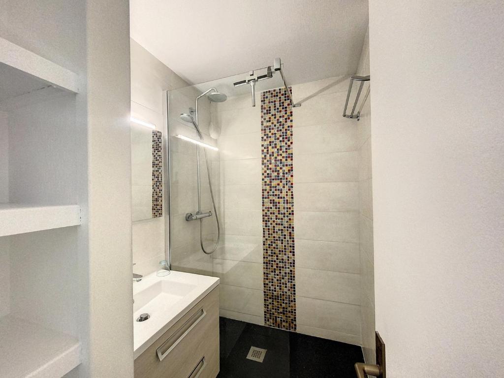 a bathroom with a shower and a sink at La Bolee d Air in Quiberon