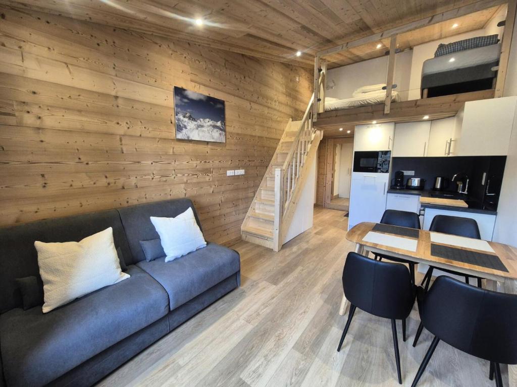 un salon avec un canapé et une table et une cuisine dans l'établissement Résidence Curling B Tour - Studio rénové · Pieds des pistes · Balcon MAE-8151, à Tignes