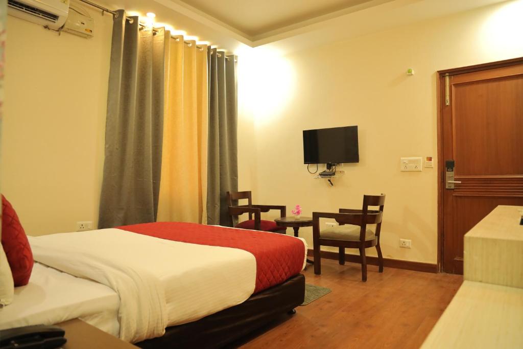 Postel nebo postele na pokoji v ubytování Hotel Nirvana Suites