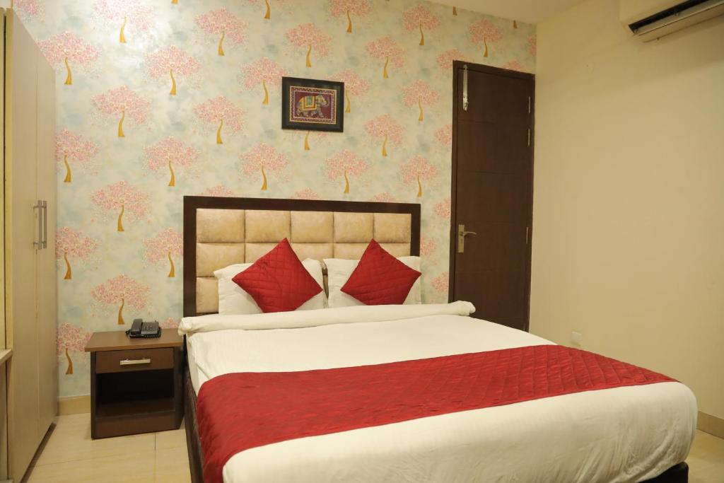 Postel nebo postele na pokoji v ubytování Hotel Nirvana Suites
