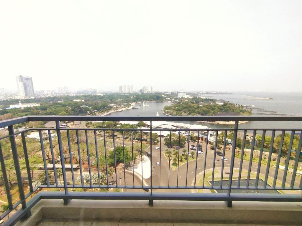 a view of the city from the balcony of a building at Ancol Mansion Apartment Sea View by Berlin Village in Jakarta