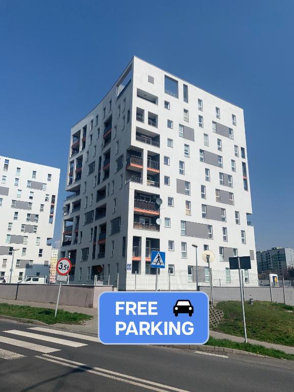 a building with a free parking sign in front of it at Apartament Kalina in Lublin