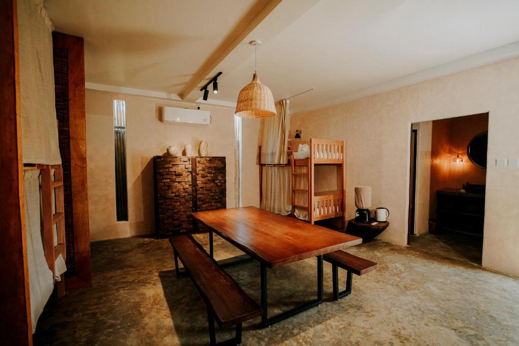 a dining room with a wooden table in a room at NYLA Boutique Resort Siargao in General Luna