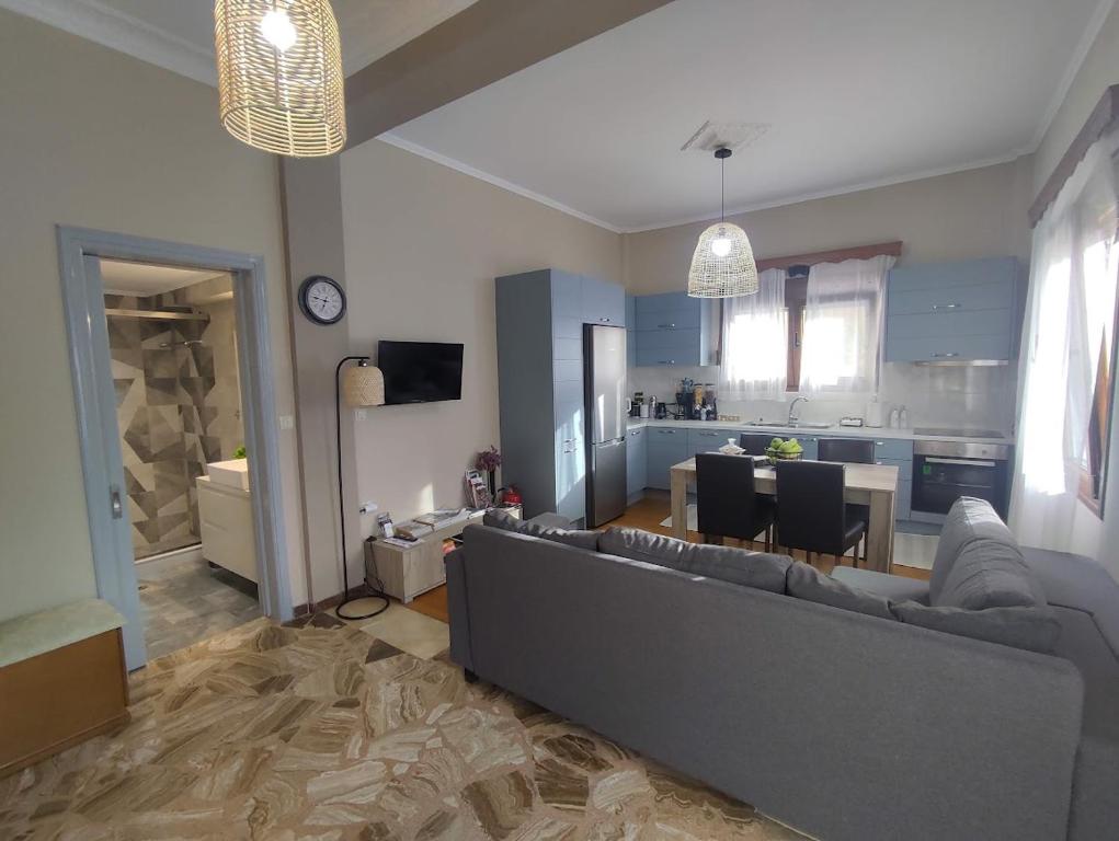 a living room with a couch and a kitchen at Myron & Gabby's House in Monemvasia