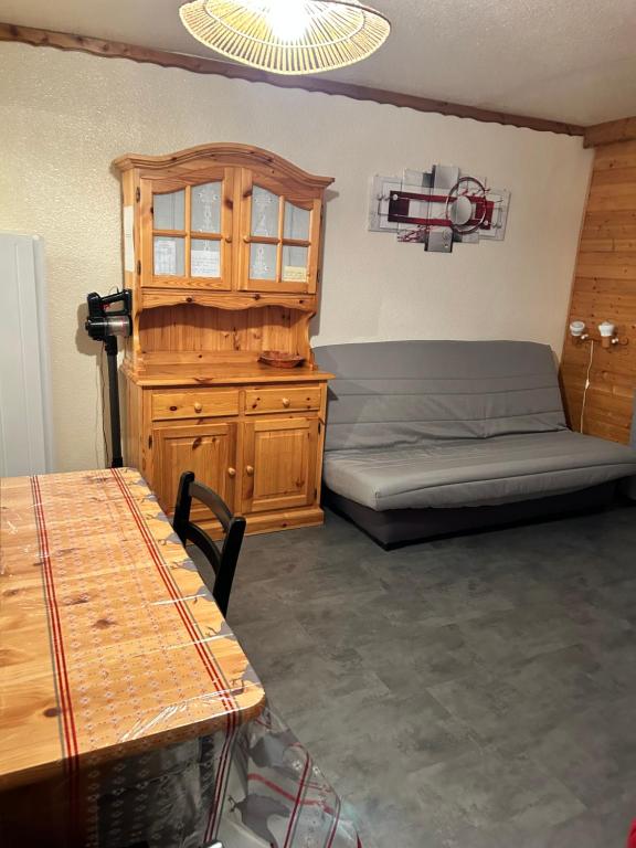 a bedroom with a bed and a wooden cabinet at Le Corbier Soyouz Vanguard in Le Corbier