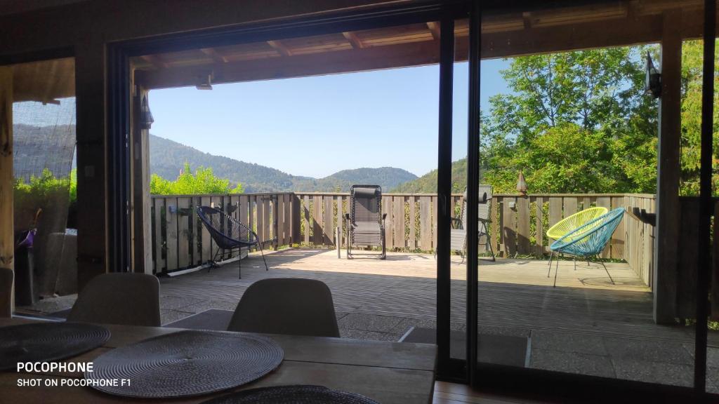 a view of a patio with a table and chairs at Chalet avec vue sur la vallée in Saint-Maurice-sur-Moselle
