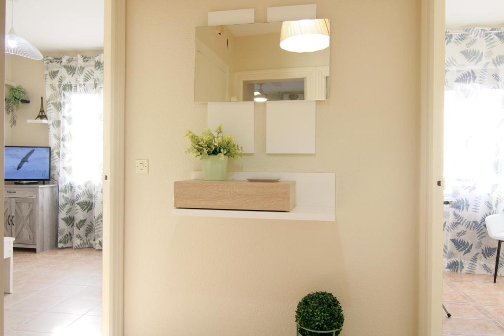 a living room with a plant on a wall at Apartamento LUNADA I in Candeleda