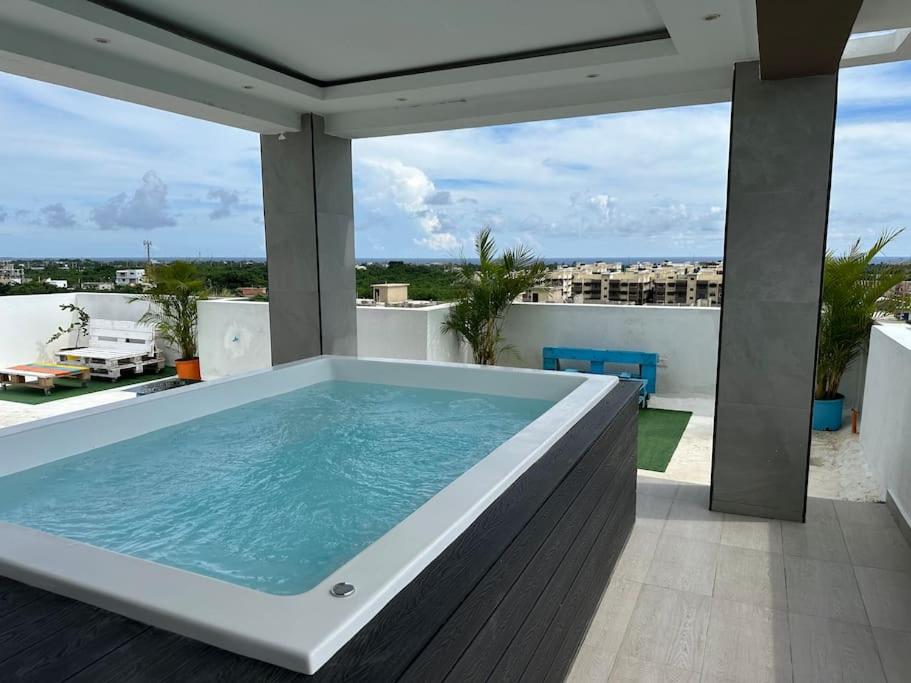 a hot tub on the balcony of a house at Apartamento santo domingo este in Juan López