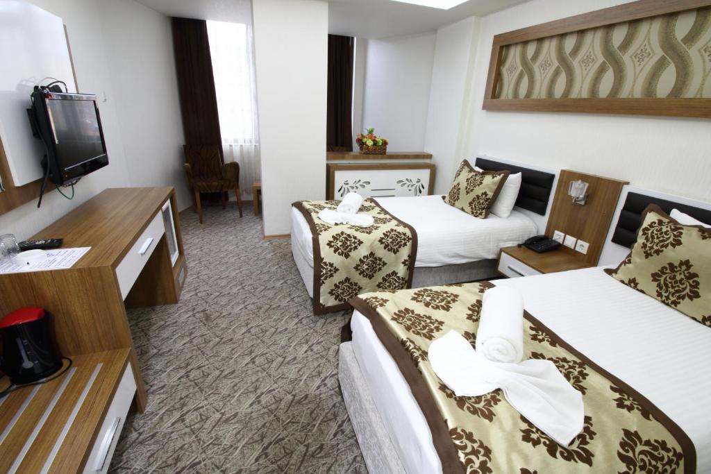 Postel nebo postele na pokoji v ubytování Afyon Grand Arı Hotel