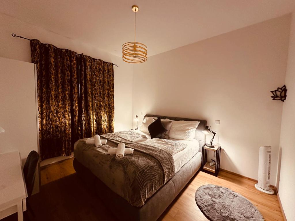 a bedroom with a bed and a large window at Schönbrunn Garden Apartments in Vienna