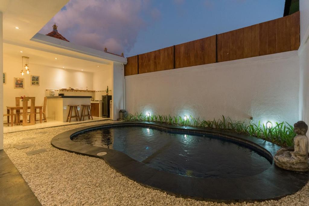 a swimming pool in the middle of a house at Villa Skyler Seminyak in Seminyak