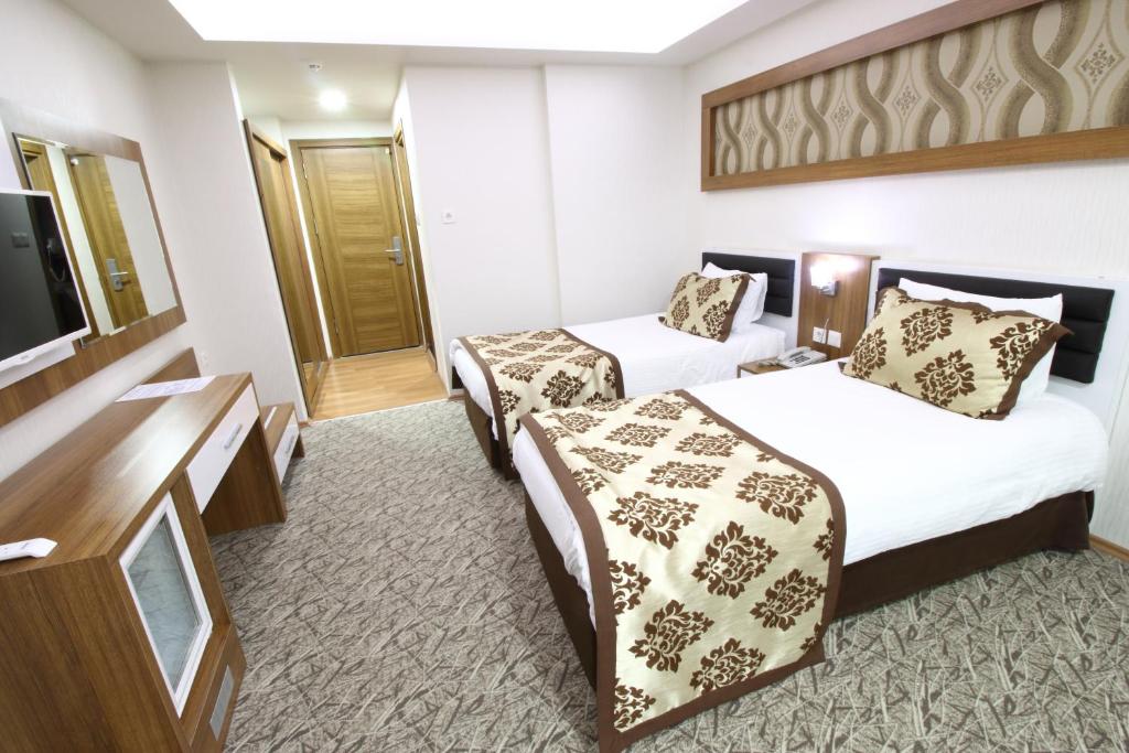 Postel nebo postele na pokoji v ubytování Afyon Grand Arı Hotel