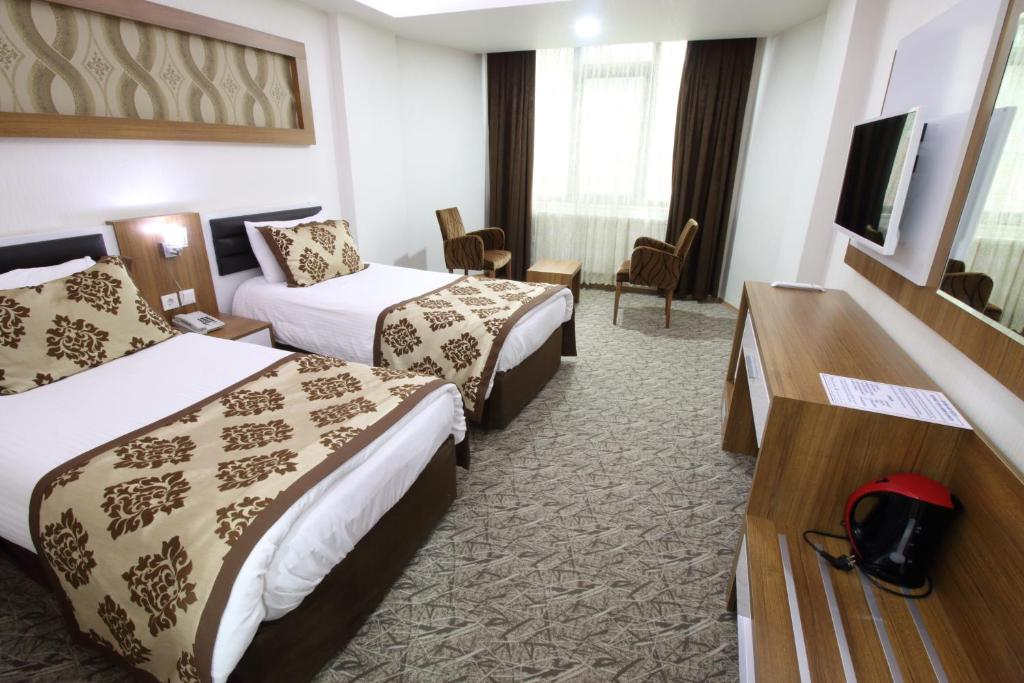 Postel nebo postele na pokoji v ubytování Afyon Grand Arı Hotel