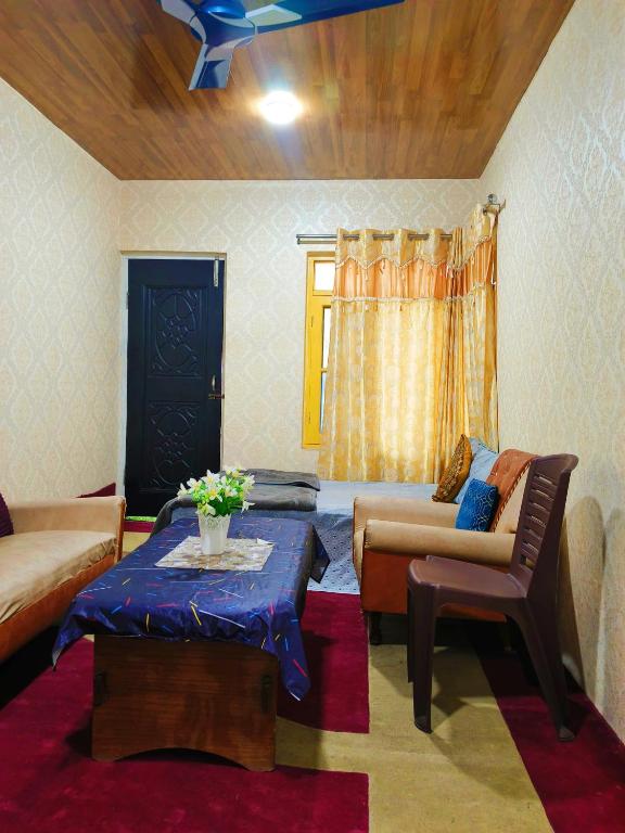 a living room with a couch and a table at Luminaire Homestay in Srinagar
