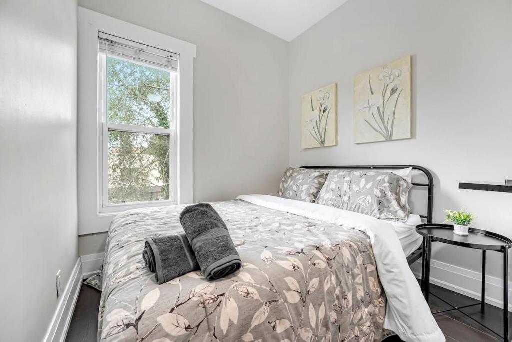 a bedroom with a bed with two pillows on it at Luxury 2BR Home Near DT GO Hospitals Waterfalls in Hamilton