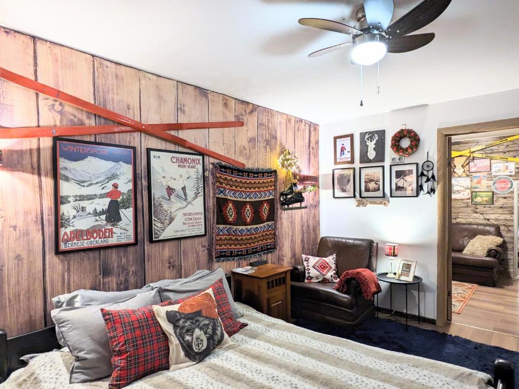 a living room with a bed and a ceiling fan at Vesetas NON-smoking One Bedroom Apartments in Rīga